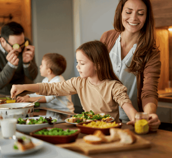 Familie bereitet gemeinsam Abendbrot-Rezepte für entspannte Sommertage zu